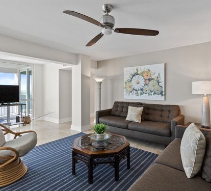 Relax in your stylish living room with ocean views, comfortable seating, and gentle ceiling fan breezes.
