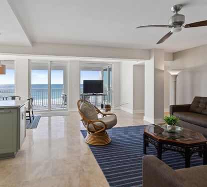 Relax in your open-plan living space where coastal blues meet modern comfort, and endless ocean views frame your perfect beach retreat.