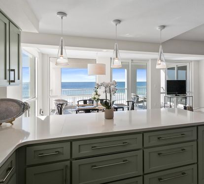 Cook with stunning ocean views from your modern kitchen, where pendant lights illuminate sleek counters and sea breezes flow through open doors.