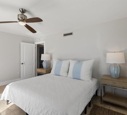 Your peaceful bedroom features soft coastal colors, crisp linens, and gentle ceiling fan breezes for restful nights.