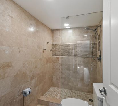 Step into your luxurious spa-like bathroom featuring a stunning walk-in shower with elegant tile work and modern glass enclosure for ultimate relaxation.