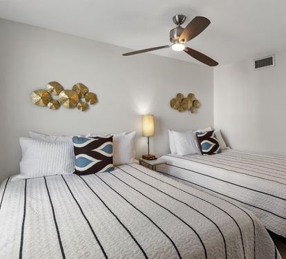 Drift off to sleep in your cozy bedroom with twin beds, soothing decor, and a ceiling fan to keep you comfortable all night.