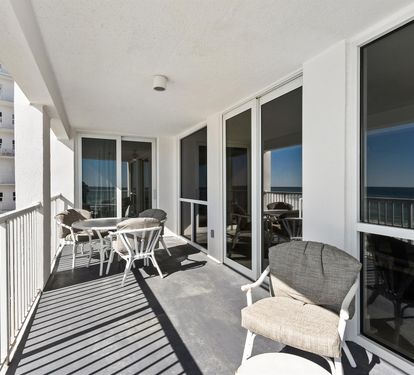 Relax on your private balcony with comfortable seating and stunning ocean views stretching to the horizon.