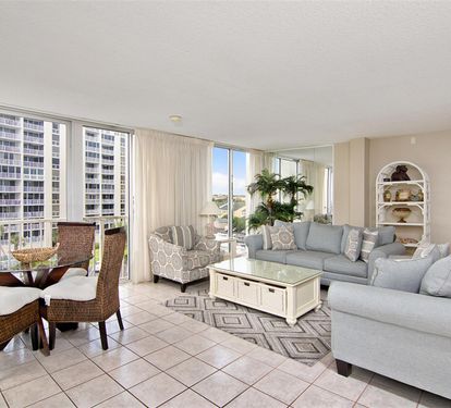 Your bright living space offers stunning city views through floor-to-ceiling windows, perfect for relaxing after exploring nearby attractions.