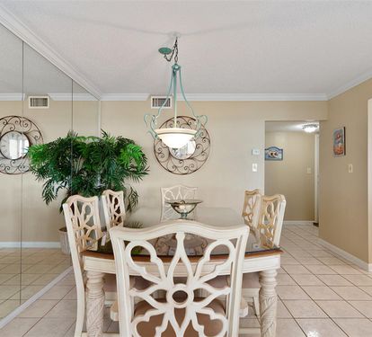 Gather around your elegant dining table for memorable meals, where decorative mirrors and warm lighting create the perfect atmosphere for every occasion.