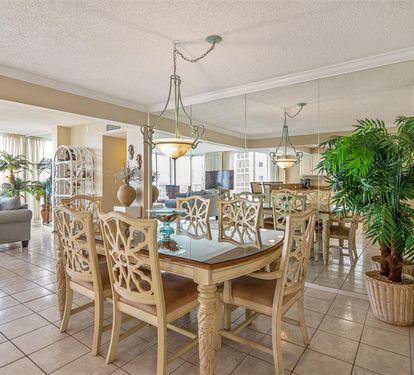 Gather around this spacious dining table where your group can share meals with stunning city views streaming through floor-to-ceiling windows.
