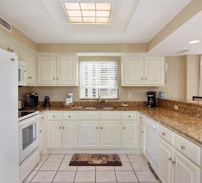 Your fully equipped kitchen offers everything you need to prepare meals, with granite countertops and modern appliances creating a welcoming cooking space.