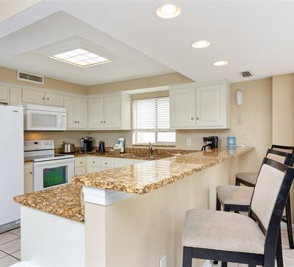Your spacious kitchen features granite countertops, modern appliances, and a breakfast bar where you can enjoy morning coffee.