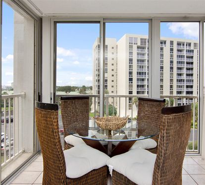 Step onto your private balcony for morning coffee with sweeping city views through floor-to-ceiling windows.