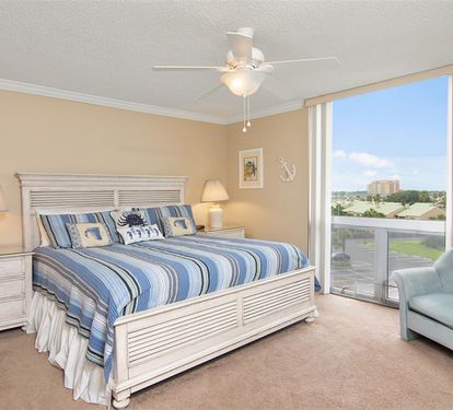 Wake up to stunning views from your spacious bedroom, where coastal-themed bedding and comfy seating create the perfect retreat for relaxation.