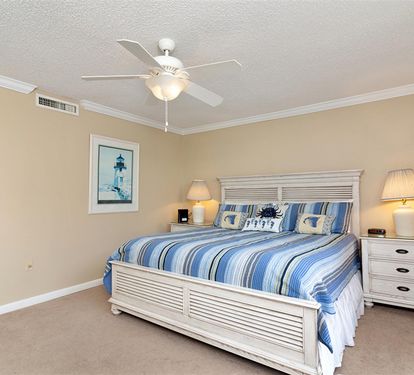 Drift off to peaceful dreams in your coastal-themed bedroom, where soft blue linens and gentle bedside lighting create the perfect sanctuary.