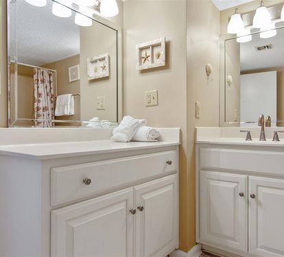 Freshen up in your spacious dual-sink bathroom with coastal accents and fresh towels waiting for your arrival.