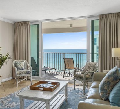 Unwind in your oceanfront living room where turquoise waters stretch endlessly beyond your private balcony and coastal breezes drift through elegant furnishings.
