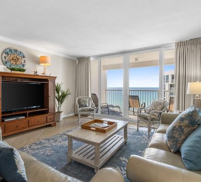 Sink into plush coastal furnishings while your private balcony frames endless ocean views through floor-to-ceiling windows.