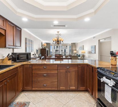 Your gourmet kitchen features rich wood cabinets, granite counters, and modern appliances—perfect for creating memorable meals during your stay.