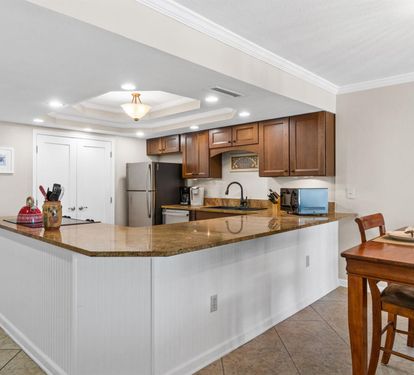 Your spacious kitchen features granite countertops, modern appliances, and a breakfast bar perfect for morning coffee or casual meals.