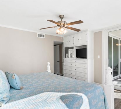 Relax in your serene bedroom with ocean-inspired decor, custom built-ins, and private balcony access for fresh coastal breezes.