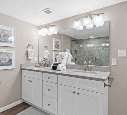Your spacious bathroom features dual sinks, elegant granite countertops, and modern lighting to start your morning refreshed.