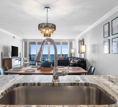 Prepare meals while gazing at stunning ocean views from your elegant kitchen, featuring marble countertops and modern amenities.