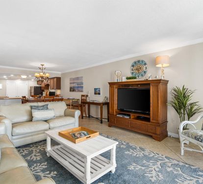 Sink into comfortable sofas and enjoy movie nights in your spacious living room, complete with entertainment center and coastal-inspired décor.