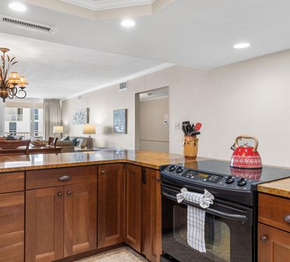 Cook your favorite meals in this spacious kitchen with granite countertops, rich wood cabinetry, and modern appliances that make every culinary adventure a joy.