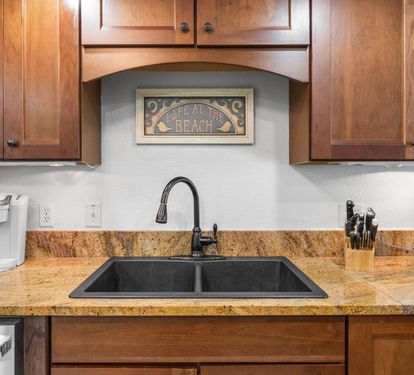 Your fully equipped kitchen features warm wood cabinets, granite countertops, and everything you need to create memorable meals during your beach getaway.