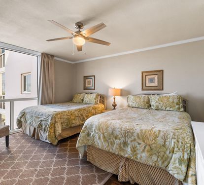 Unwind in your bright twin-bed retreat with tropical touches, ceiling fan comfort, and peaceful street views.