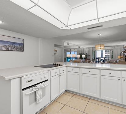 Your bright kitchen opens to the living area, creating the perfect space for cooking while staying connected with your guests.