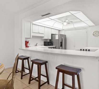 Your bright kitchen offers modern appliances and a breakfast bar where you can enjoy morning coffee or casual meals together.