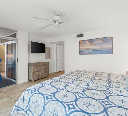 Drift off to peaceful sleep in your coastal bedroom with soft blues, ocean artwork, and private balcony access to the sea breeze.