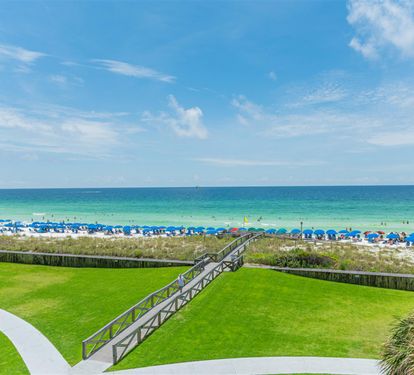 Beachfront property offers direct access to pristine white sand beach with turquoise waters and convenient boardwalk.