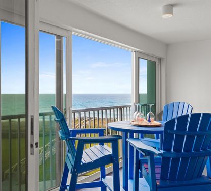 Your private balcony awaits with ocean views and comfortable seating for morning coffee or sunset cocktails.
