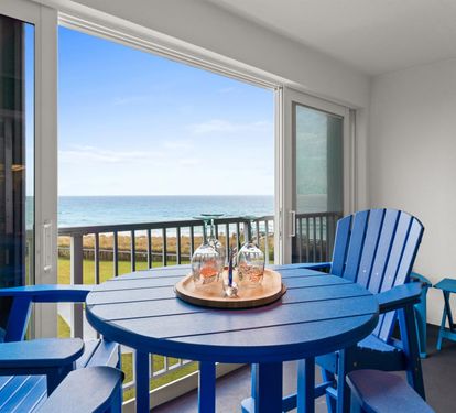 Sip wine at your private table while endless ocean views stretch to the horizon from your seaside balcony retreat.