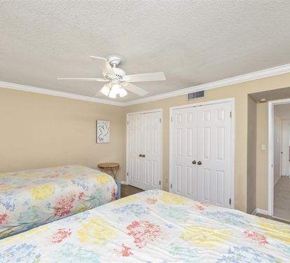 Rest peacefully in your bright bedroom with twin beds, ceiling fan, and ample closet storage for all your vacation essentials.