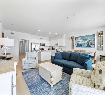 Unwind in your spacious open-plan haven where coastal blues meet crisp whites, perfect for relaxing after beach days.