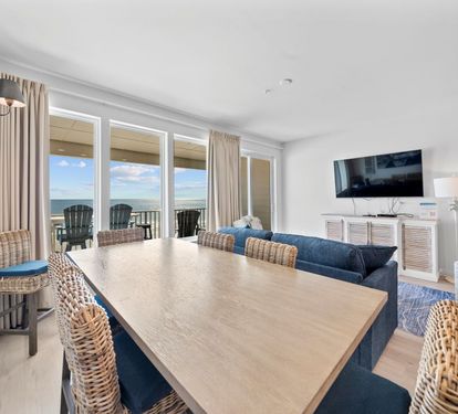 Savor meals with stunning ocean views through floor-to-ceiling windows in your bright, coastal-inspired dining space.