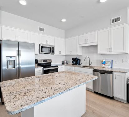 Your modern kitchen features granite counters, stainless appliances, and ample cabinet space for memorable meal preparation.