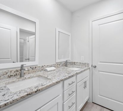 Your pristine bathroom features elegant granite countertops and dual sinks, perfect for getting ready together.