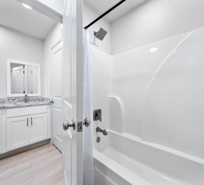 Step into your pristine bathroom with modern finishes, granite countertops, and a refreshing shower-tub combo for ultimate relaxation.