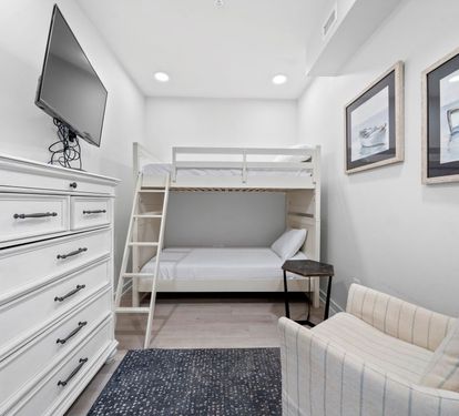 Your cozy bedroom features a space-saving bunk bed and comfortable seating area, perfect for relaxing after your adventures.