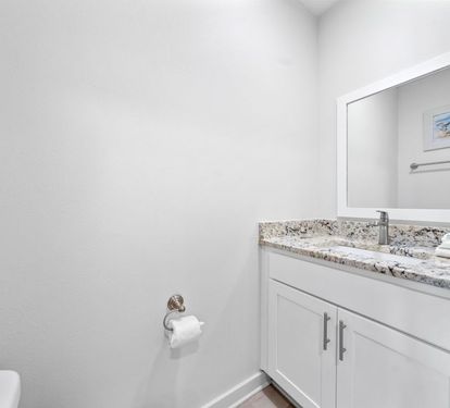 Refresh in your pristine guest bathroom with granite countertops and modern fixtures, complete with fresh towels waiting for you.