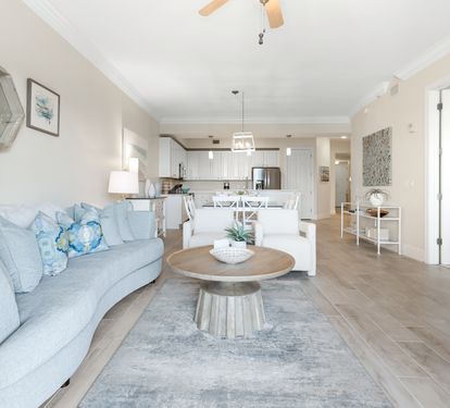 Sink into plush coastal comfort where the living room flows seamlessly into your fully equipped kitchen, creating the perfect space to unwind and gather.