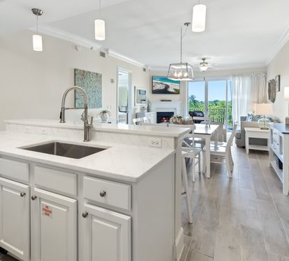 Your bright, open kitchen flows seamlessly into the living and dining areas, perfect for gathering and creating memories together. Soft pendant lighting, modern appliances, and calming coastal décor invite you to unwind.