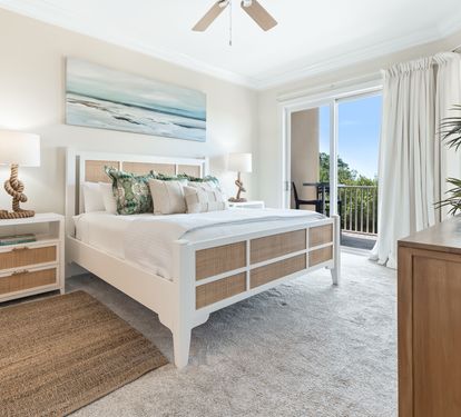 Your serene coastal retreat awaits with a plush bed, soothing ocean-inspired decor, and private balcony access where you can unwind with natural light and refreshing breezes.