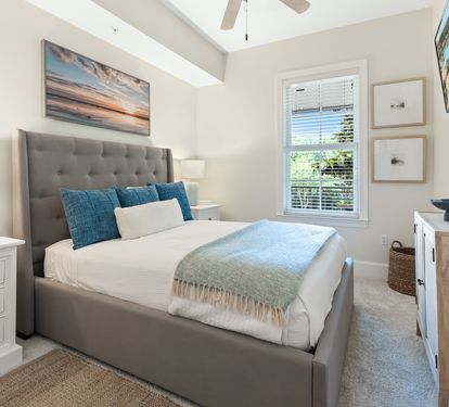 Sink into the plush upholstered bed and let the coastal artwork transport you to peaceful shores. The soft bedding and bright, airy space create your perfect retreat.
