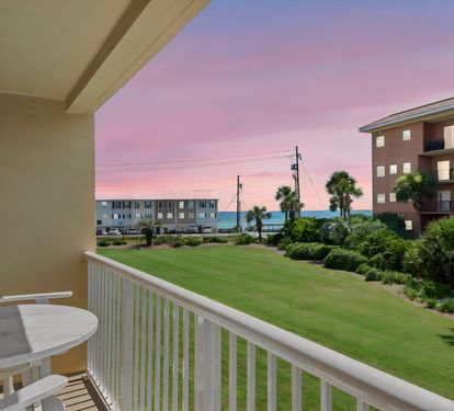 Catch stunning pastel sunsets from the balcony, where palm trees frame ocean glimpses and your coastal escape begins each evening.