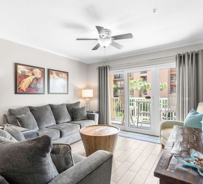Enjoy your bright, airy living room, where a private balcony invites you to soak in the sunshine and fresh air just beyond the glass doors.