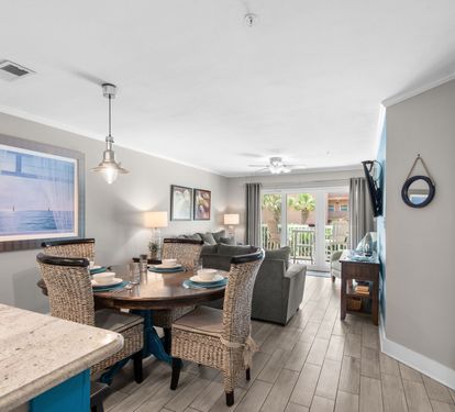 Step into your living space where natural light and beachy tones welcome you home. Gather around the dining table or relax on the sofa, with easy access to your private balcony and peaceful views beyond.