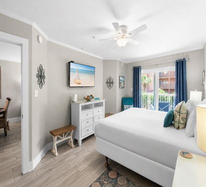 Soft ocean breezes welcome you to your primary bedroom with balcony access. Unwind under gentle ceiling fan as natural light fills your peaceful retreat.
