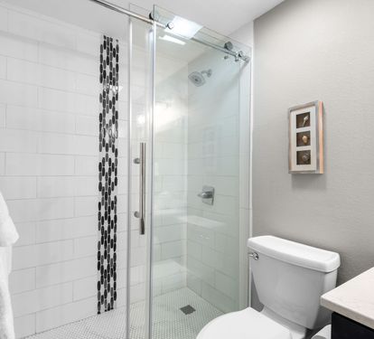 Refresh in your stylish, modern bathroom with a spacious walk-in shower and crisp white subway tiles.